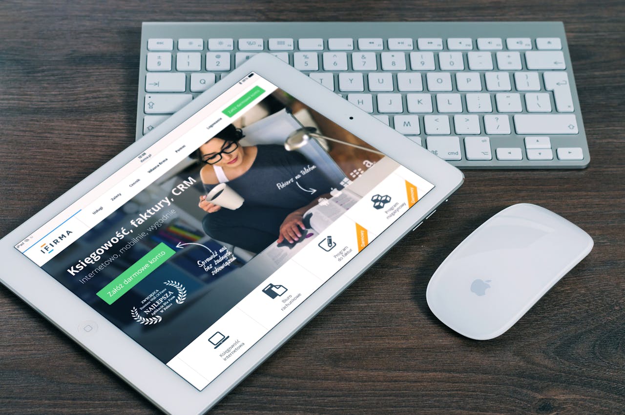 mobile-01 A tablet with a financial website open, alongside a white keyboard and mouse. Ideal for tech-theme stock images.