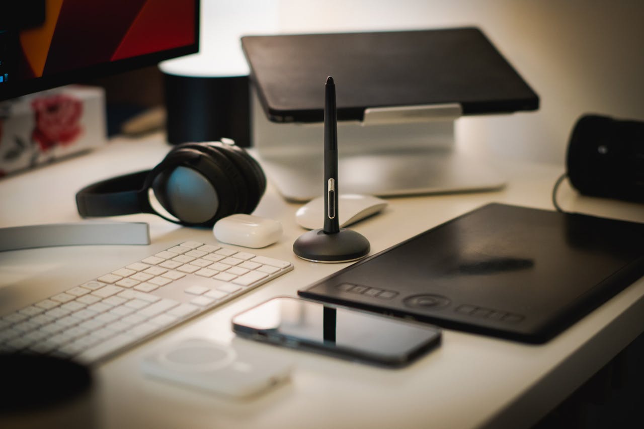 Services-01 A sleek home office setup with digital tools including a tablet, keyboard, and headphones.