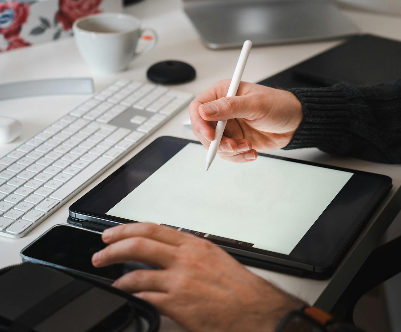 digital Designer working with a tablet and stylus in a modern workspace setup.