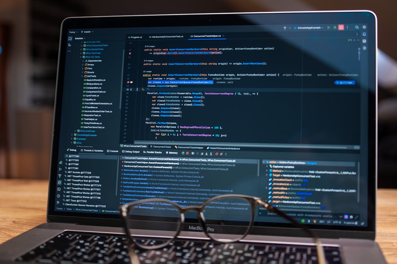 creative-03 Laptop screen showing debugging software with code, perfect for tech and software development themes.
