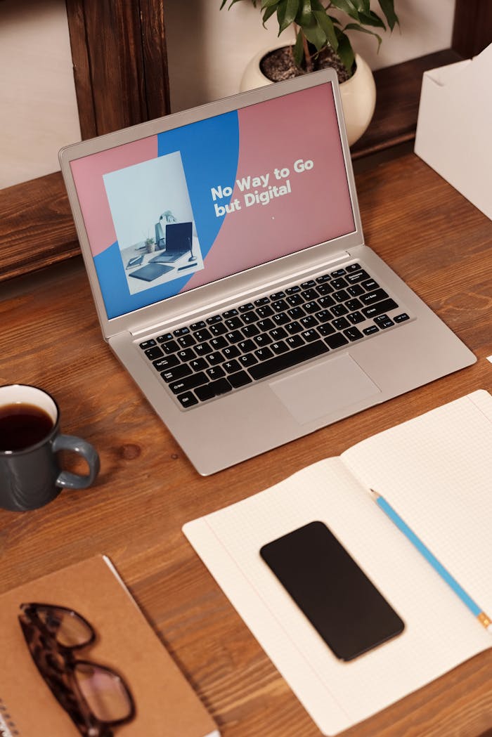 why-choose-us A neatly organized desk featuring a laptop displaying digital content, coffee, and office supplies.